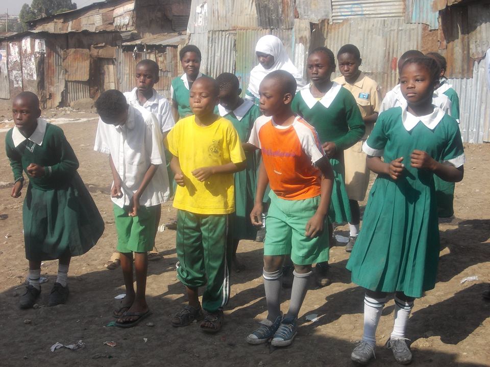 Children in Mathare with a volunteer